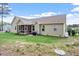 Large backyard featuring an enclosed back porch, grill, shed, and expansive green lawn at 115 Mill Run Ln, Sanford, NC 27330