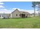 Expansive backyard featuring lush green lawn, a screened-in porch, and mature trees at 115 Mill Run Ln, Sanford, NC 27330