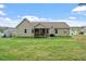 Large backyard with a screened-in porch, perfect for outdoor activities and relaxation at 115 Mill Run Ln, Sanford, NC 27330