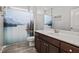This bathroom includes a shower with curtain and a dark wood vanity and mirror at 115 Mill Run Ln, Sanford, NC 27330