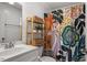 The bathroom has an eye-catching shower curtain, decorative shelves, and modern vanity at 115 Mill Run Ln, Sanford, NC 27330
