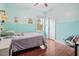 Bedroom view with a turquoise accent wall, hardwood floors, and natural light at 115 Mill Run Ln, Sanford, NC 27330