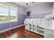 This is a bedroom with hardwood floors, natural lighting, and a fan at 115 Mill Run Ln, Sanford, NC 27330