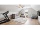 Spacious bonus room with a sectional sofa, exercise equipment, and lots of natural light at 115 Mill Run Ln, Sanford, NC 27330