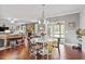 Open-concept dining area features hardwood floors, a cozy table, and backyard access at 115 Mill Run Ln, Sanford, NC 27330