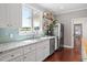 This kitchen sink offers stainless steel appliances, light countertops, and backyard views at 115 Mill Run Ln, Sanford, NC 27330