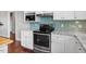 Modern kitchen with stainless steel appliances, white cabinetry, and stylish backsplash at 115 Mill Run Ln, Sanford, NC 27330