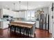 Bright kitchen features white cabinets, tile backsplash, an island, and stainless steel appliances at 115 Mill Run Ln, Sanford, NC 27330
