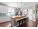 Bright kitchen showcases white cabinets, a large island with seating, and backyard views at 115 Mill Run Ln, Sanford, NC 27330