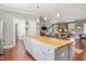 A bright kitchen that opens to the living room is equipped with an island and appliances at 115 Mill Run Ln, Sanford, NC 27330