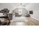 Attic space with a sectional couch, treadmill, tv, and carpet at 115 Mill Run Ln, Sanford, NC 27330