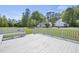 A white painted wood back deck overlooks the yard and wooded area, offering a relaxing space for outdoor enjoyment at 1156 Darius Pearce Rd, Youngsville, NC 27596