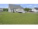 Backyard featuring a deck, lush lawn, and mature trees, offering a serene and private outdoor setting at 1156 Darius Pearce Rd, Youngsville, NC 27596