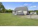 Backyard view featuring a spacious deck and chain link fence, perfect for relaxing and secure outdoor enjoyment at 1156 Darius Pearce Rd, Youngsville, NC 27596