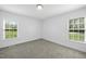Bright bedroom features neutral carpet, fresh paint, two windows offering natural light at 1156 Darius Pearce Rd, Youngsville, NC 27596