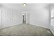 Bright bedroom features neutral carpet, fresh paint, and an open doorway at 1156 Darius Pearce Rd, Youngsville, NC 27596