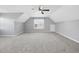 Expansive bonus room features neutral carpet, fresh paint, and a window offering natural light at 1156 Darius Pearce Rd, Youngsville, NC 27596