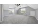 Expansive bonus room features neutral carpet, fresh paint, and two windows offering natural light at 1156 Darius Pearce Rd, Youngsville, NC 27596