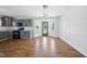Dining area with hardwood floors, modern lighting, and access to the kitchen, ideal for entertaining and Gathering meals at 1156 Darius Pearce Rd, Youngsville, NC 27596