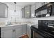 Close-up of kitchen with stainless steel sink, black appliances, and ample counter space at 1156 Darius Pearce Rd, Youngsville, NC 27596