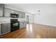 Open kitchen with black appliances flows into an open area, great for entertaining at 1156 Darius Pearce Rd, Youngsville, NC 27596