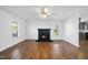 Bright living room with a ceiling fan, fireplace, and large windows, creating a cozy and inviting atmosphere at 1156 Darius Pearce Rd, Youngsville, NC 27596