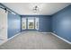 Bright primary bedroom boasts large windows and blue walls, creating a serene atmosphere at 1156 Darius Pearce Rd, Youngsville, NC 27596