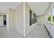 Covered porch with vinyl siding, white trim, and dark shutters, showcasing the home's exterior detail and curb appeal at 1156 Darius Pearce Rd, Youngsville, NC 27596