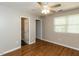 Bedroom featuring hardwood floors, ceiling fan, and access to attached bathrooms at 116 Old Maple Ln, Durham, NC 27713
