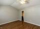 Bedroom featuring hardwood floors, ceiling fan, and access to ensuite bathroom at 116 Old Maple Ln, Durham, NC 27713
