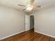 Neutral bedroom features hardwood floors and a lighted ceiling fan at 116 Old Maple Ln, Durham, NC 27713