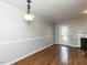 Cozy living room boasts hardwood floors, a fireplace, and white trim at 116 Old Maple Ln, Durham, NC 27713