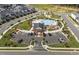 High angle view of a community pool, clubhouse, playground, parking, and well manicured lawns in a neighborhood at 1245 Porters Call Dr, Wendell, NC 27591
