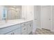 Elegant bathroom featuring double vanity, shower and a decorative patterned tile floor at 1245 Porters Call Dr, Wendell, NC 27591