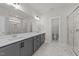 Beautiful bathroom with marble flooring, dual vanities, and a large glass-enclosed shower at 1245 Porters Call Dr, Wendell, NC 27591