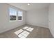 Sunlit bedroom with neutral walls, carpet, and views of the neighborhood at 1245 Porters Call Dr, Wendell, NC 27591