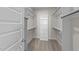 Spacious walk in closet with shelving, rods, and carpeted flooring at 1245 Porters Call Dr, Wendell, NC 27591