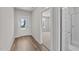 Bright entryway with wood flooring, white door, and view into a carpeted room at 1245 Porters Call Dr, Wendell, NC 27591