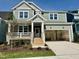 Charming two-story home with an attached garage, porch and manicured front yard at 1245 Porters Call Dr, Wendell, NC 27591