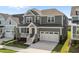 Attractive two-story home with covered front porch, stone accents, and a convenient two-car garage at 1245 Porters Call Dr, Wendell, NC 27591