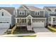 Charming two-story home with a covered front porch, two-car garage, and well-maintained lawn at 1245 Porters Call Dr, Wendell, NC 27591