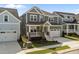 Lovely two-story home boasts a charming front porch, attached two-car garage, and well-kept lawn at 1245 Porters Call Dr, Wendell, NC 27591