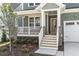 Inviting front porch with stone pillars, white railings, and a view of the manicured front yard at 1245 Porters Call Dr, Wendell, NC 27591