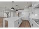 Open kitchen featuring a large center island, stainless appliances, and sleek white cabinetry at 1245 Porters Call Dr, Wendell, NC 27591