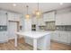 Beautiful kitchen featuring a large island, modern stainless appliances and stylish lighting at 1245 Porters Call Dr, Wendell, NC 27591
