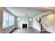 Bright living room with a fireplace, hardwood floors, and natural light, perfect for relaxing and entertaining guests at 1245 Porters Call Dr, Wendell, NC 27591