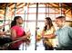 Vibrant restaurant scene with friends enjoying drinks under a modern, airy design and sunlit ambiance at 1245 Porters Call Dr, Wendell, NC 27591