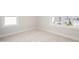 Carpeted room with two windows displaying neighborhood homes at 1245 Porters Call Dr, Wendell, NC 27591