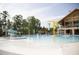 A splash pad with a slide and bucket fountain next to the main community pool at 1245 Porters Call Dr, Wendell, NC 27591