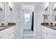 Bright bathroom featuring double vanities, modern fixtures, and stylish tile flooring at 1309 Pecora Ln, Raleigh, NC 27607